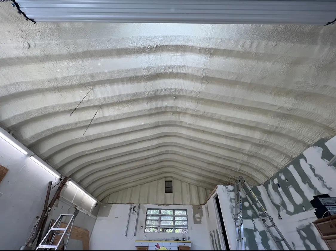 Spray polyurethane foam applied to the underside of a metal roof deck in Paxton